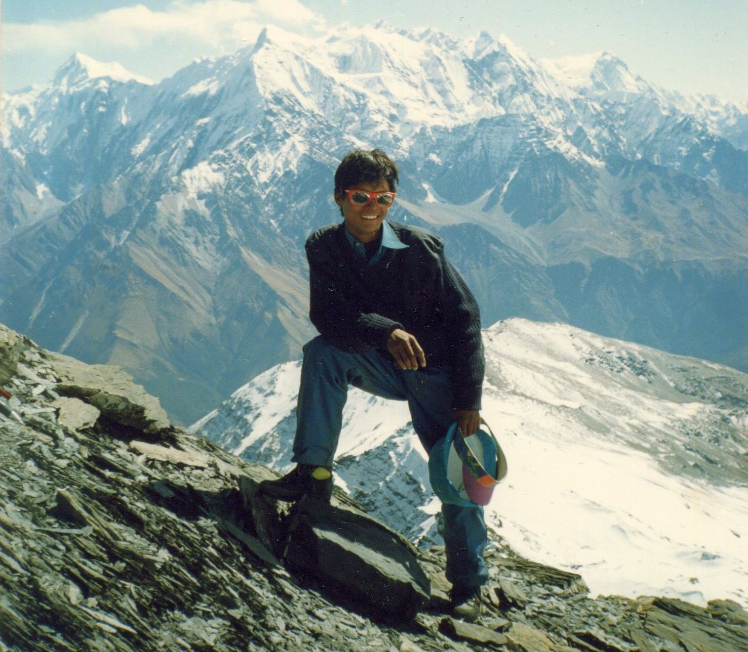 Nima Lakpa Sherpa on summit of Thapa Peak with Annapurna Himal in background