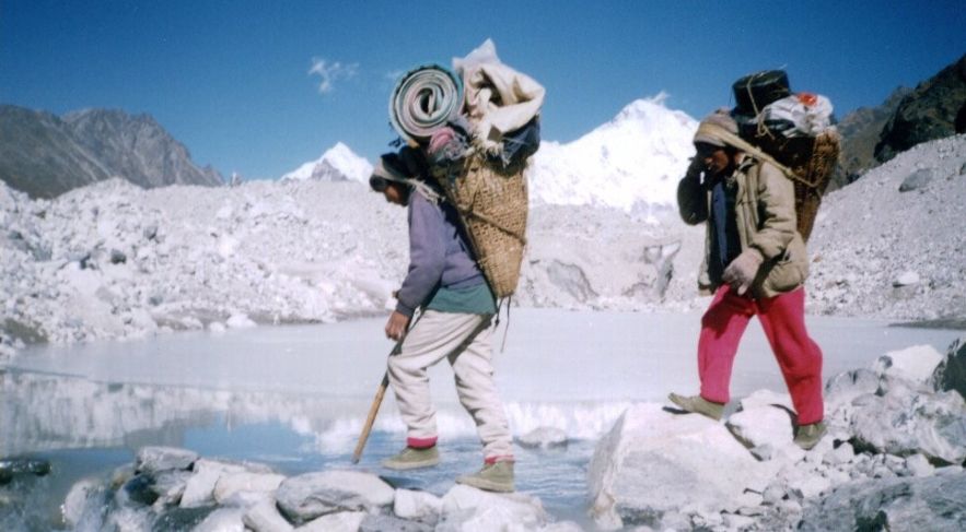 Porters Crossing Ngozumpa Glacier on route to Gokyo